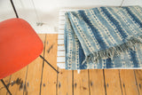 Hand woven African indigo textile with unique ivory and denim blue striped pattern, short tassels.