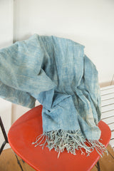 Vintage African textile throw's powder blue hand-woven fabric and distinctive long tassels.