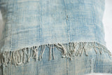 Reclaimed African Indigo pillow with sun-faded texture and short frayed tassels.