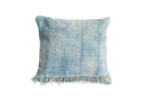 Vintage light blue indigo pillow, sun-faded with woven vertical stripes and short fringe.