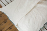 Pillow's ivory European linen back with envelope enclosure and short tassels.