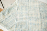 Visible panel seams and hand-woven texture of a light powder blue African textile.