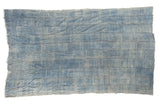 Vintage African indigo textile throw, hand woven with denim blue horizontal stripes and frayed edges.