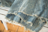 Handwoven denim blue African textile displaying its rich texture and distinctive frayed edges.