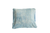 Close-up of the sun-faded texture on the light blue African Indigo textile pillow.