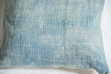 Close-up of reclaimed vintage African indigo pillow with sun-faded blue vertical stripes.