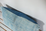 Sun-faded light blue vintage indigo textile meeting medium blue cotton canvas back.