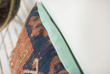 Faded turquoise European linen backing contrasting antique Kazak rug fragment.