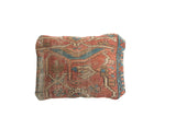 Worn red and blue geometric pattern detail on an antique Heriz rug fragment pillow.