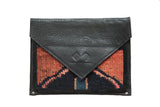 Handmade Rug Fragment Clutch featuring a bold red and black vintage Turkish Oushak design.