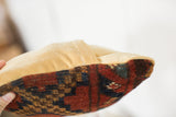 Hand-knotted antique Afghani rug fragment in red and blue with gold velvet back, envelope enclosure.