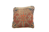 Antique Caucasian rug fragment pillow, geometric motifs in rustic red, lovely blue, and natural wear.