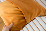Tangerine orange velvet pillow back, showcasing the soft texture and envelope enclosure.