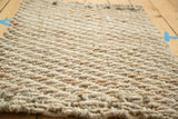 Tight hand-braided texture of the durable natural fiber ivory entrance mat.