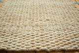 Detailed hand-braided texture of the ivory entrance mat, showing natural fibers.