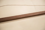 Detail of the rich, dark grain on the handmade walnut wood rod.