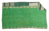 Vibrant green vintage Kantha quilt featuring small floral patterns, ornamental border, and contrasting textile panels.