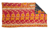 Vibrant Kantha Quilt with magenta, orange, and yellow floral design, showing dark blue patterned reverse.