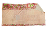 Neutral-toned Kantha quilt detail with pink floral borders, hand-stitched texture, and folded green reverse.