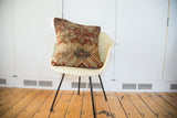 Pillow made from antique Mahal rug fragment featuring softened terracotta, aqua, and beige geometric motifs.