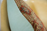 Terracotta and aqua geometric Mahal rug fragment pillow side, joined with light blue fabric.