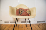 Pair of antique Kilim pillows showcasing faded terracotta and blue geometric motifs.