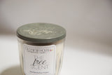 Aged green zinc lid with embossed design on the antique jelly jar soy candle.