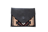 Handmade Rug Fragment Clutch features black suede and beige, navy, rust geometric pattern.