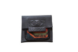 Rug Fragment Coin Purse, dark leather with vibrant geometric hand-knotted textile.