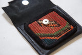 Rug Fragment Coin Purse with hand-knotted red, green, blue pattern and metallic snap.