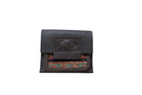 Dark brown leather Rug Fragment Coin Purse with colorful geometric hand-knotted rug pattern.