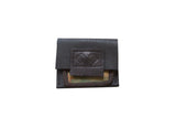 Dark brown leather coin purse with embossed emblem and colorful geometric rug fragment.