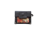 Handmade black leather coin purse with hand-knotted rug fragment in red, cream, 5x4 inches.