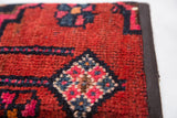 Handmade Rug Fragment Clutch, rich red pile with blue and pink geometric pattern, dark edge.