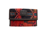Handmade Rug Fragment Clutch with vibrant geometric pattern in red, black, and teal.