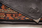Embossed Swag and Tassel logo on the pebbled leather flap with a decorative metal corner.