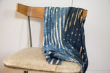 Collectible hand woven African indigo textile in deep blue with natural patterns.