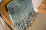 African Indigo pillow's fringed edge reveals sun-faded blue textile and light blue linen.