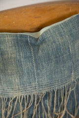 Sun-faded African Indigo textile with visible hand-stitching, fringed edge, and light blue linen back.