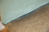 Light blue linen and sun-faded African Indigo textile meeting at pillow edge.