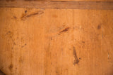 Rustic wood grain, visible knots, and worn patina on the vintage serving board surface.