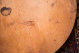 Close-up of vintage wooden pizza board surface showing rich wood grain and dark patina.