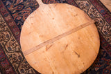 Natural wood grain, rustic patina, and center strip on the vintage wooden pizza board.