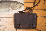 Vintage 1950s brown leather messenger bag with worn finish and two buckle straps.