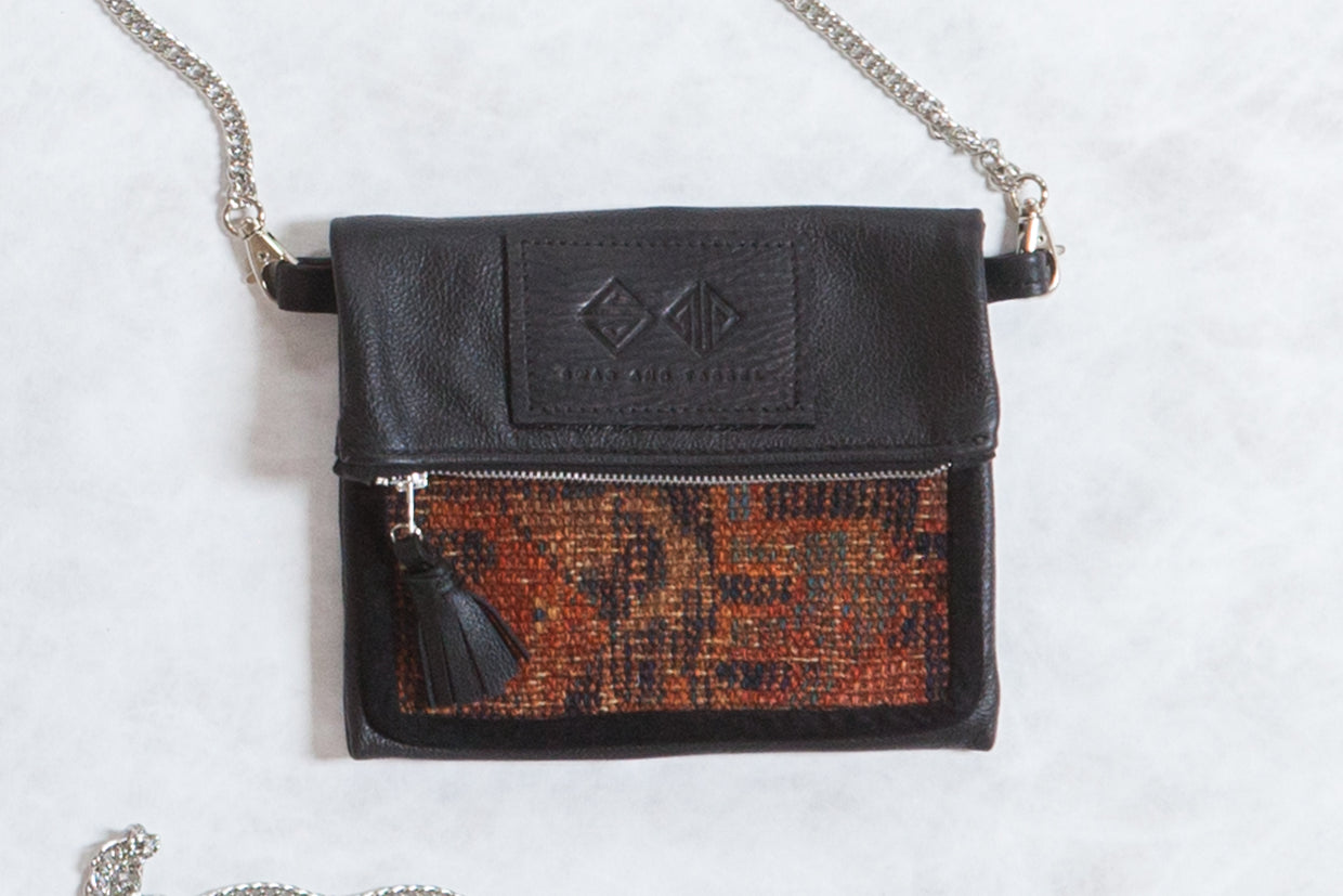 Antique Kurdish Rug Fragment Bag with dark leather and geometric terracotta, blue, brown pattern.
