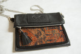 Antique Kurdish rug fragment, woven rust orange and blue pattern, black leather zipper.