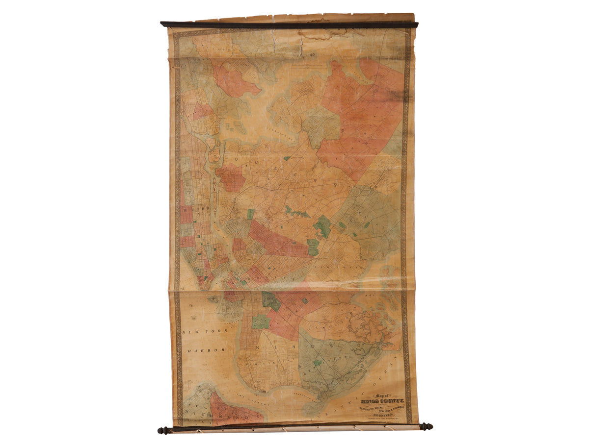 Antique Kings County wall map, unfurled to show its aged patina and faded color-coded boroughs.