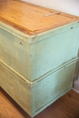Industrial factory cart's light minty green distressed paint and reclaimed wood top.
