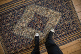 Scale view of the hand-woven texture on an antique Persian Senneh Kilim rug.