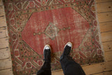 Vintage Malayer square rug, overhead view: diamond medallion, worn blush field, geometric border.